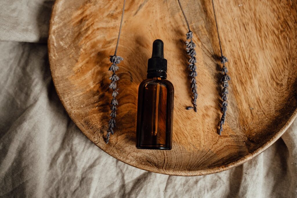 Black and Brown Glass Bottle on Brown Wooden Round Tray